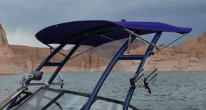 Samson Sports wakeboard tower with a bimini top, on a boat floating on a lake
